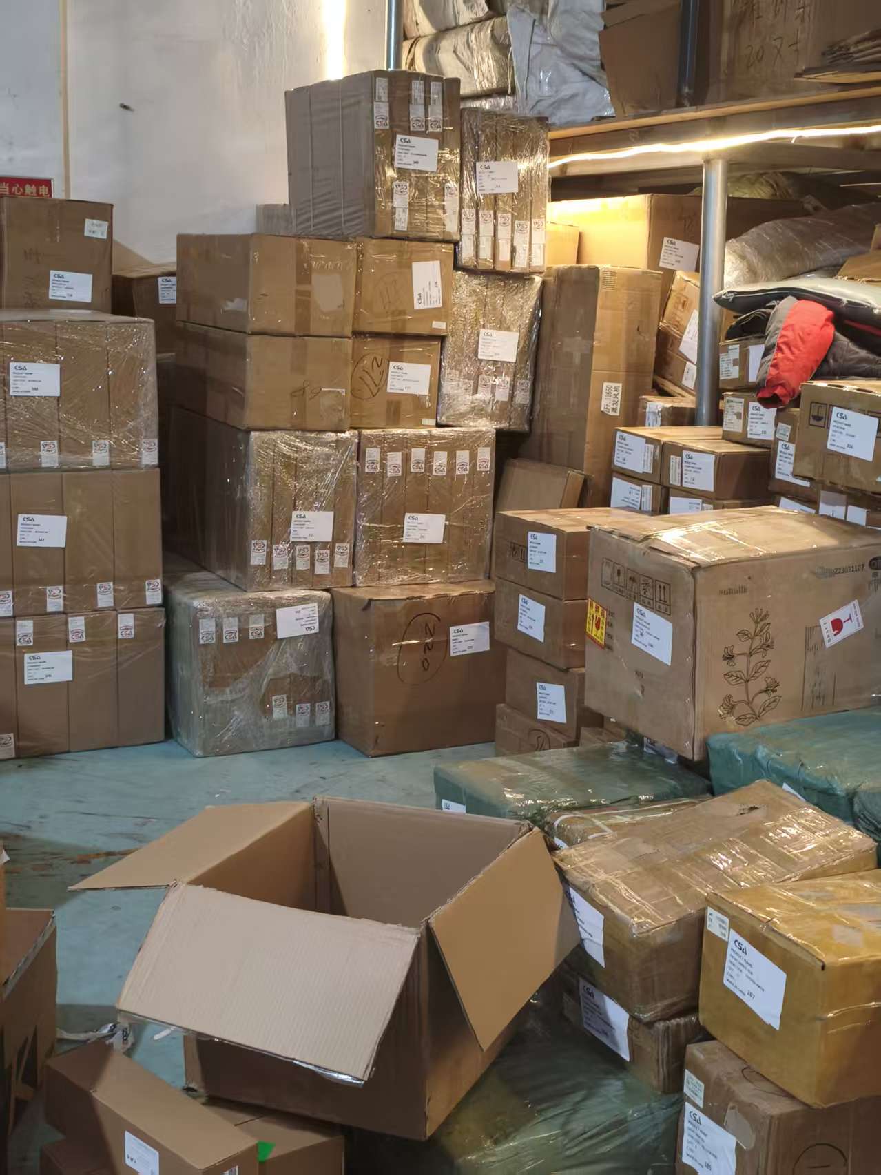 Stacked export cartons labeled with CSA tracking codes — ready for international shipment