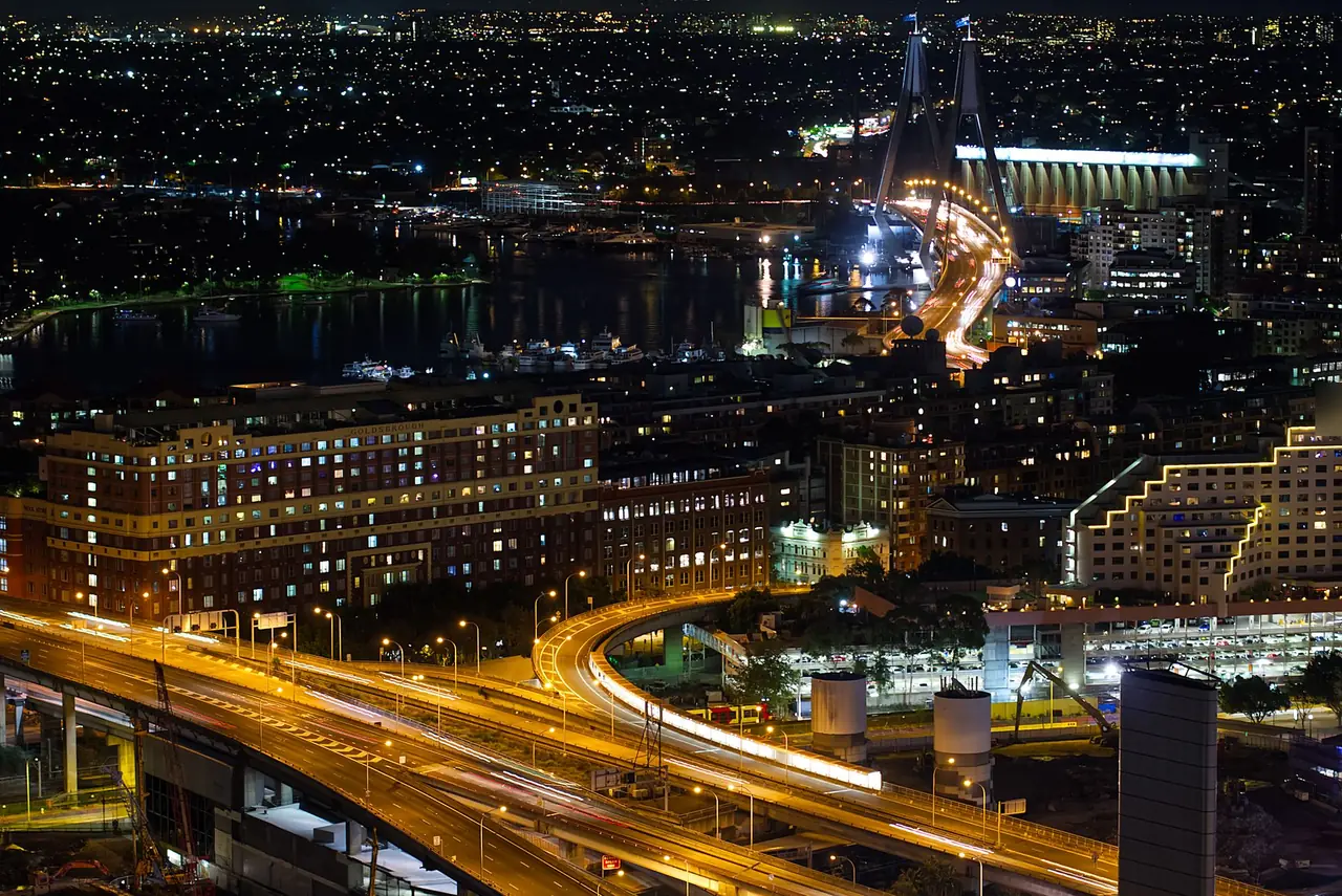 Sydney, Australia at night: freeway traffic trails leading to Anzac Bridge
